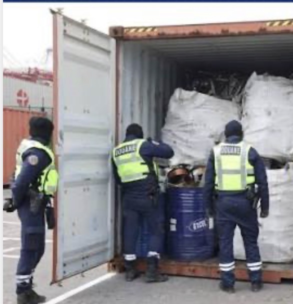 Supplied photograph showing customs officers beside an open shipping container