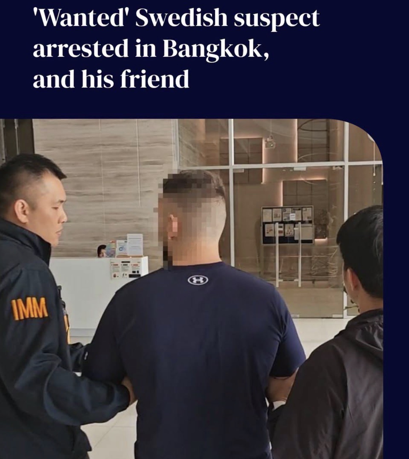 Supplied image showing a Swedish suspect being escorted in Bangkok, with face obscured