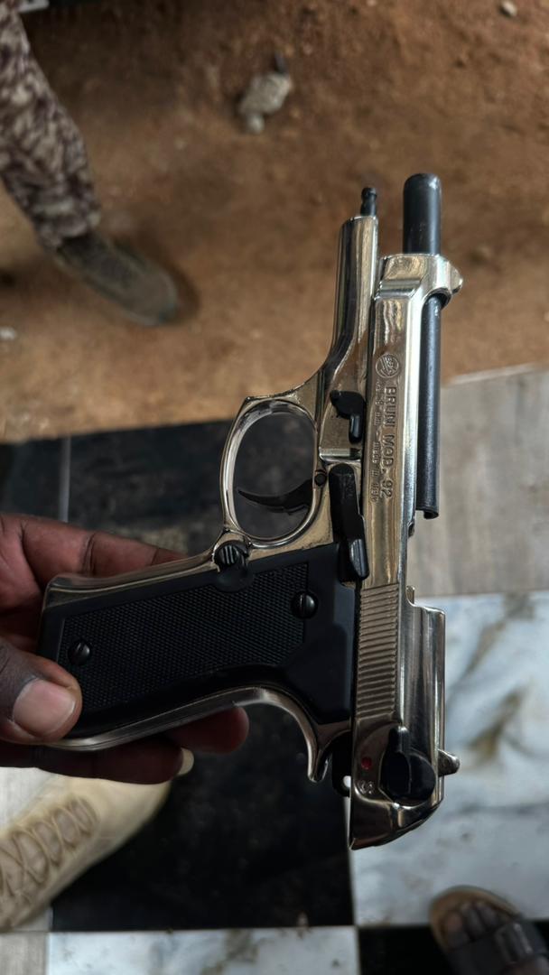 Supplied close-up of a firearm reportedly retrieved during the operation